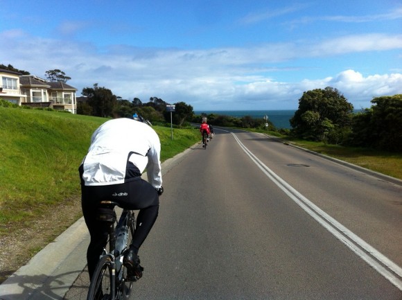 Marcus (foreground) and Dougie (background) riding The Esplanade toward Safety Beach.